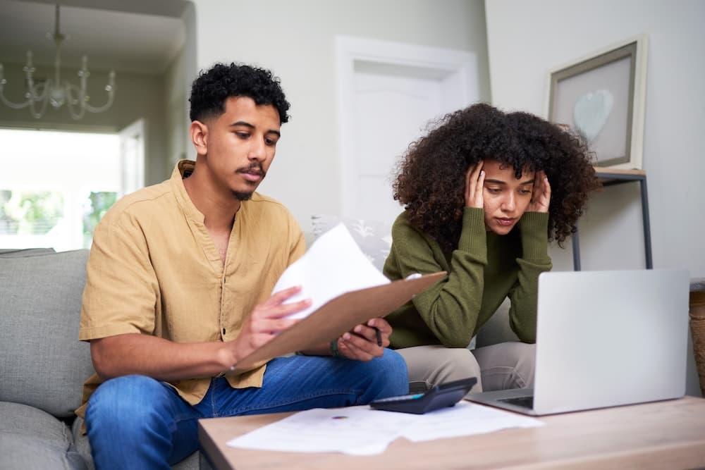 Frustrated couple dealing with leasehold problems in their home